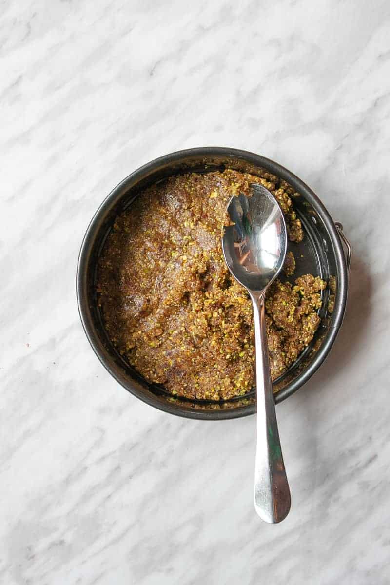 Date and pistachio mixture pressed down into pan with a spoon