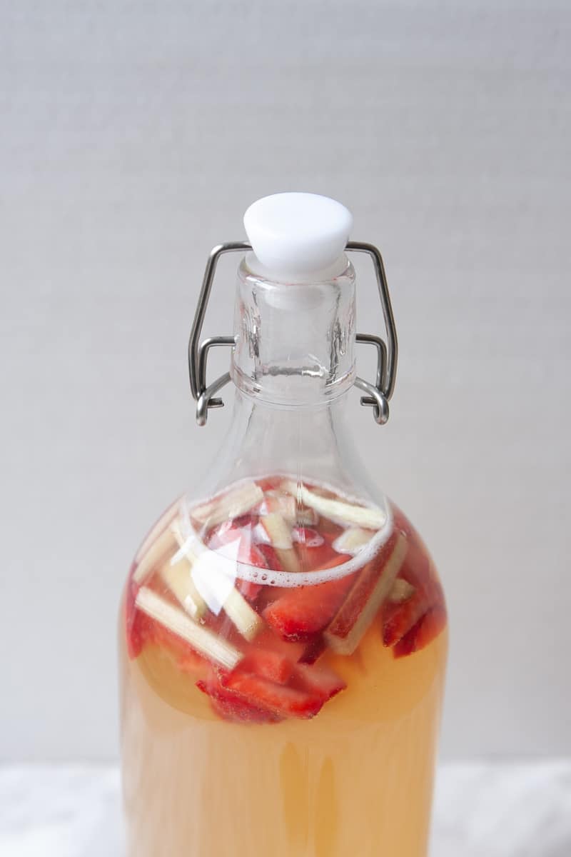 Close-up of bottle with strawberry rhubarb kombucha