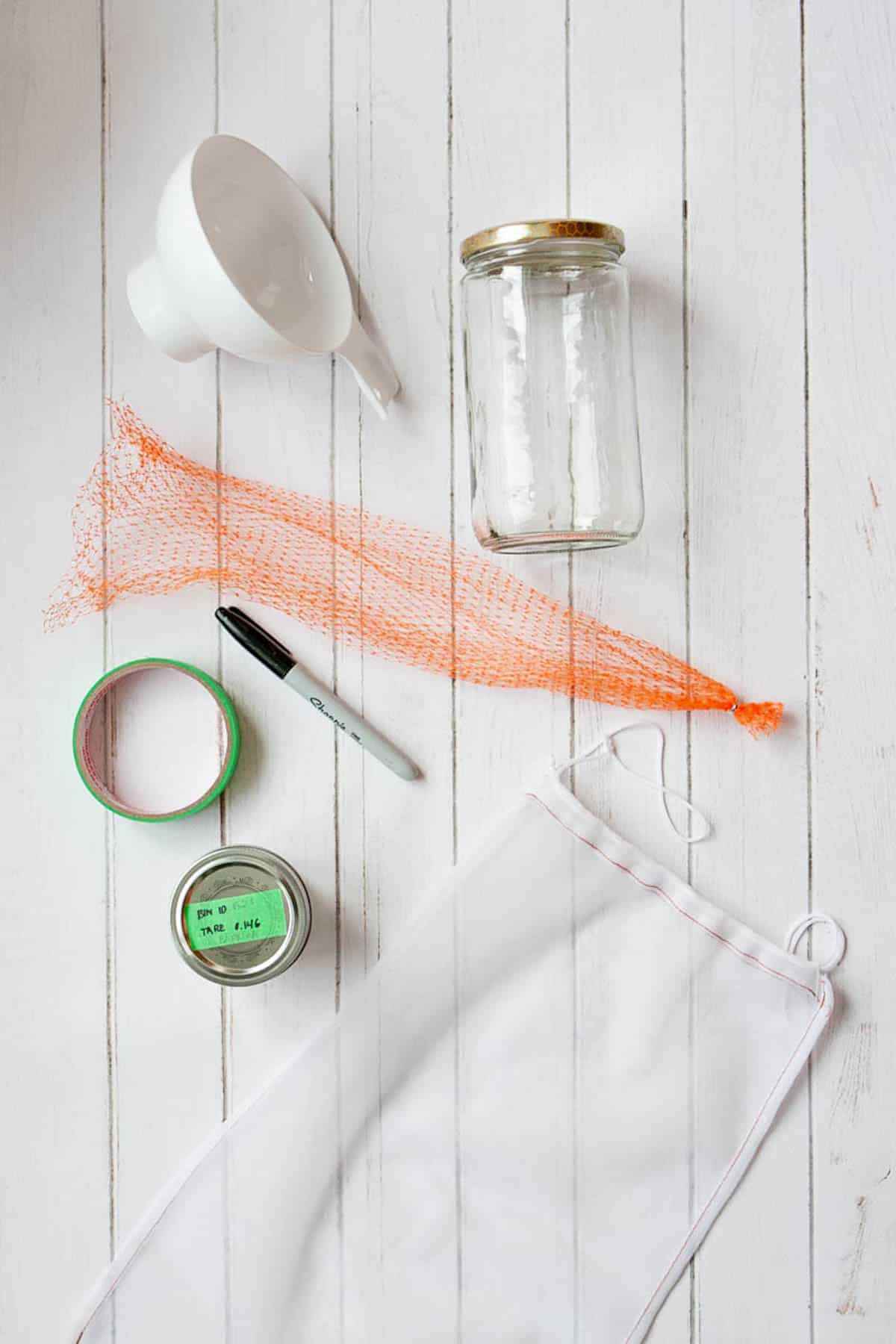 funnel, glass jar, reusable bag, tape, marker